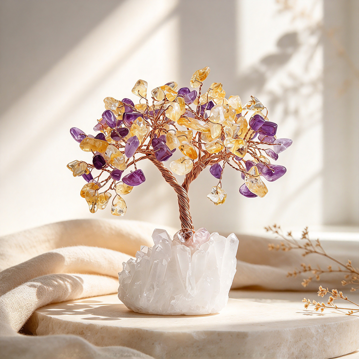 Citrine and Amethyst crystal tree, 5 inch gemstone tabletop decor, on a round marble pedestal beside a cream throw in warm window light.