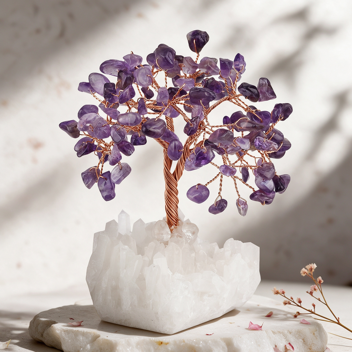 5-inch amethyst gemstone tree scene with purple amethyst chips as leaves on hand-wrapped copper branches, a white clear quartz cluster base, and dried pink flowers beside it.